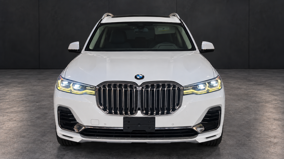BMW X7 front view with edited lighting and dark background.