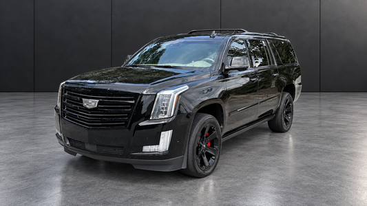 Cadillac Escalade ESV front three-quarter view with edited background and lighting.